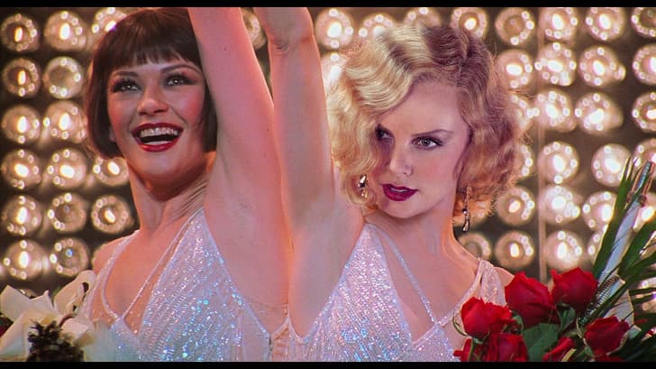 Charlize Theron as Roxie Hart (Chicago)