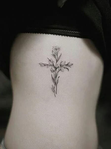 14. Cross Tattoos – With flowers