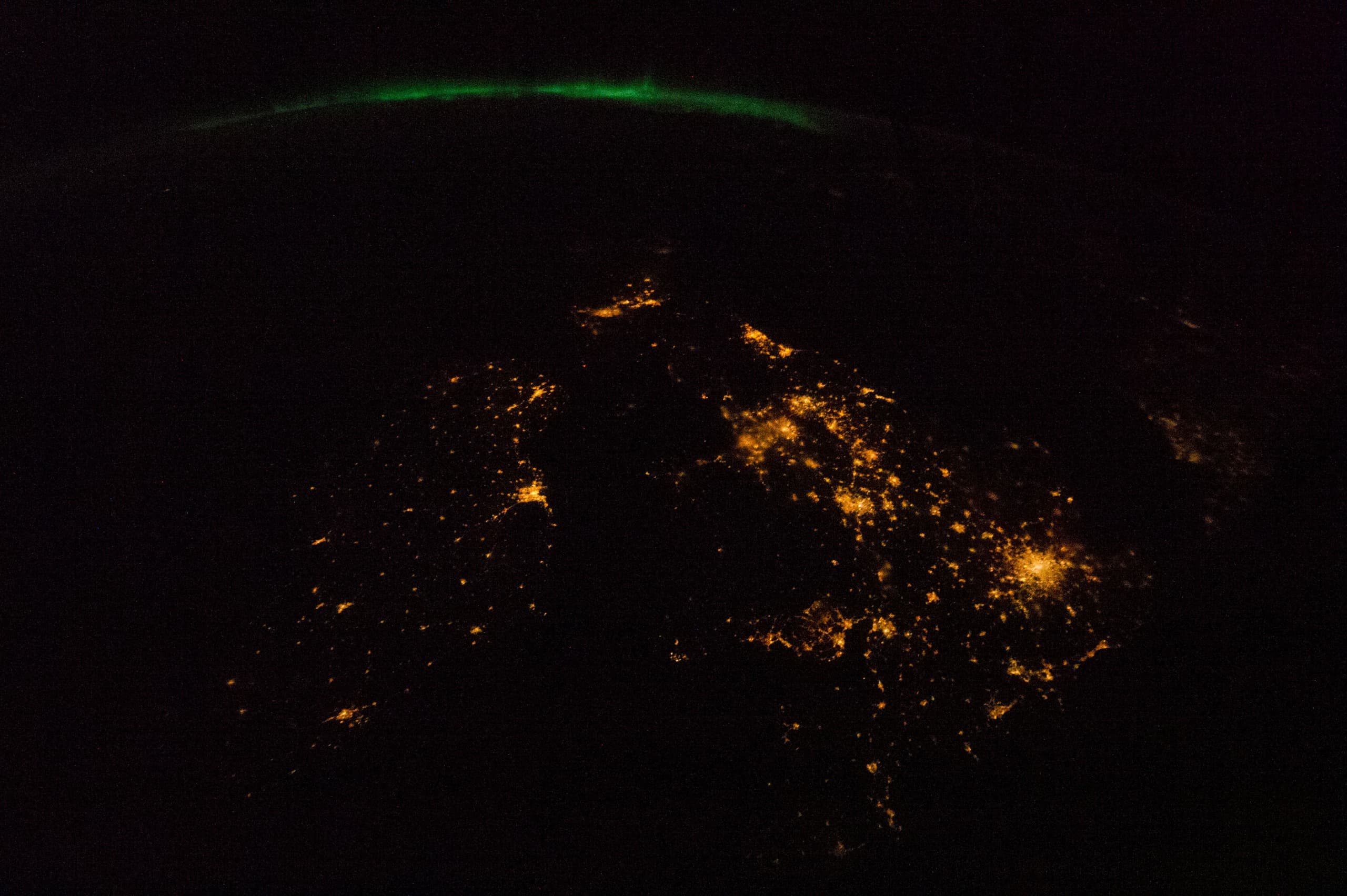 The British Isles: City Lights Beneath an Aurora