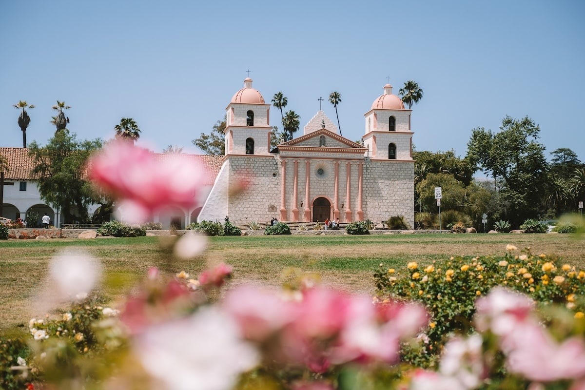 Old Mission in Santa Barbara with pink roses in the foreground