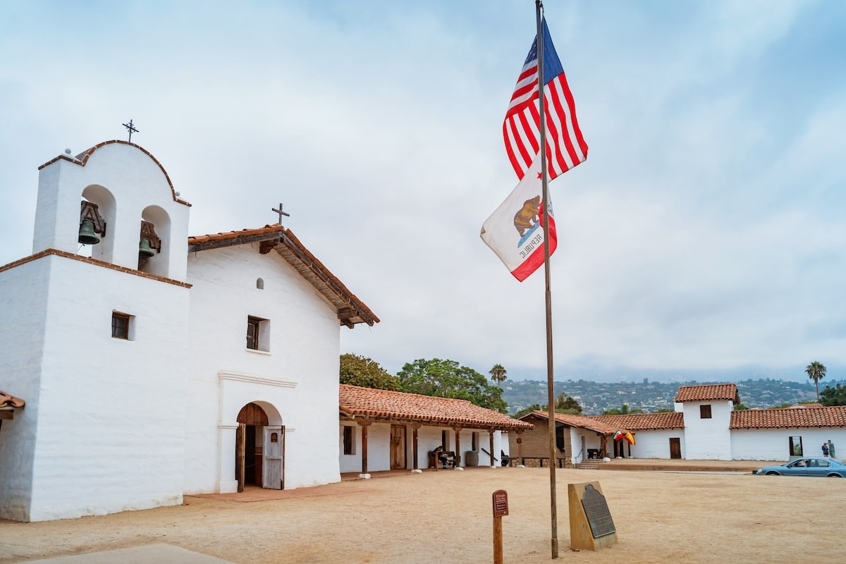 El Presidio de Santa Barbara State Historic Park with California and USA flags in foreground